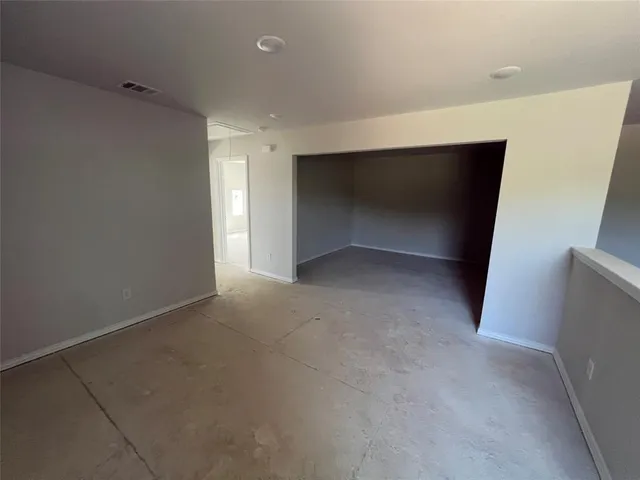 a view of an empty room with a closet