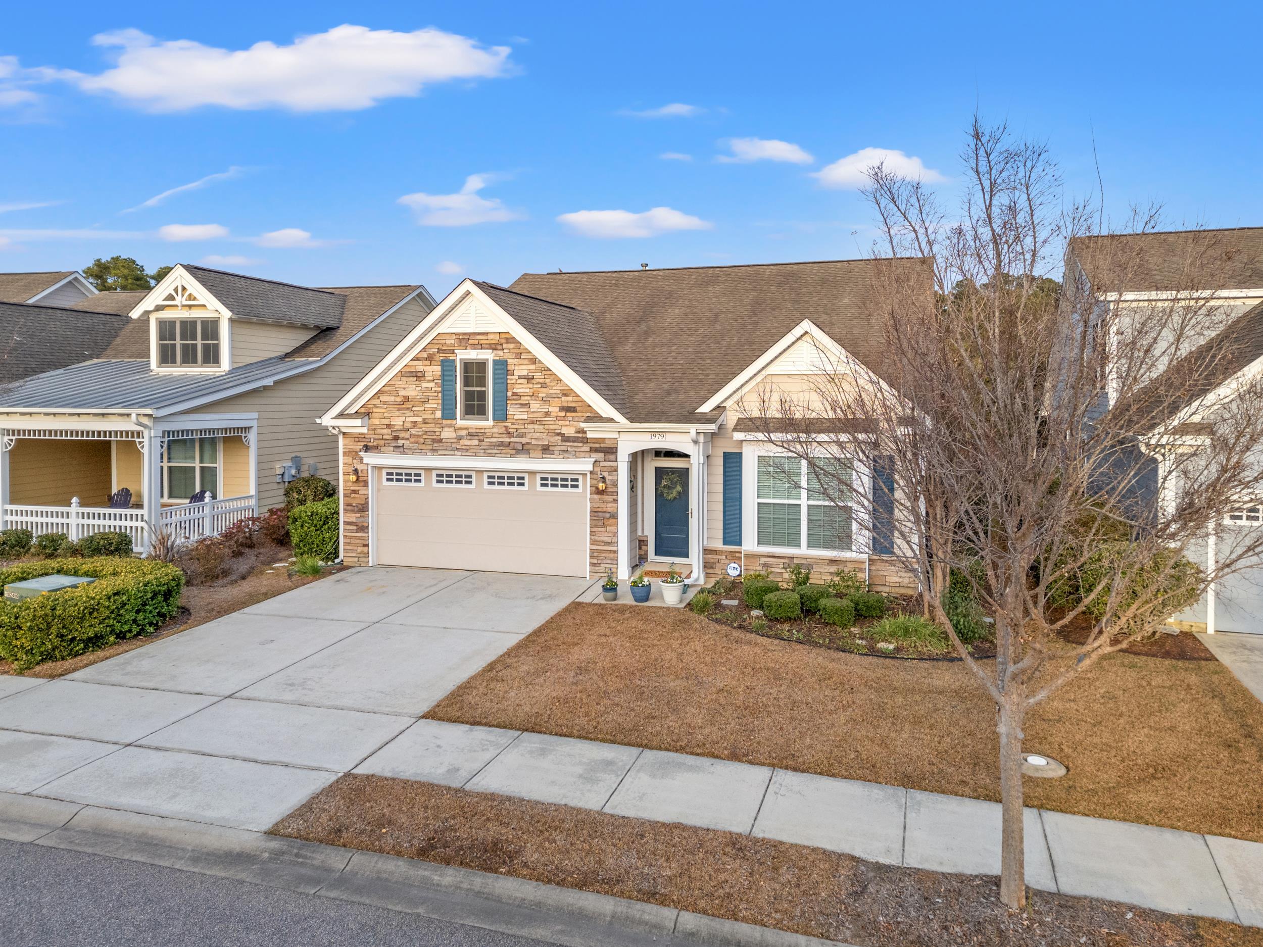 1979 Suncrest Drive Myrtle Beach, SC 29577 - Photo 11 of 28 Craftsman-style house with stone siding, concrete driveway, and a garage