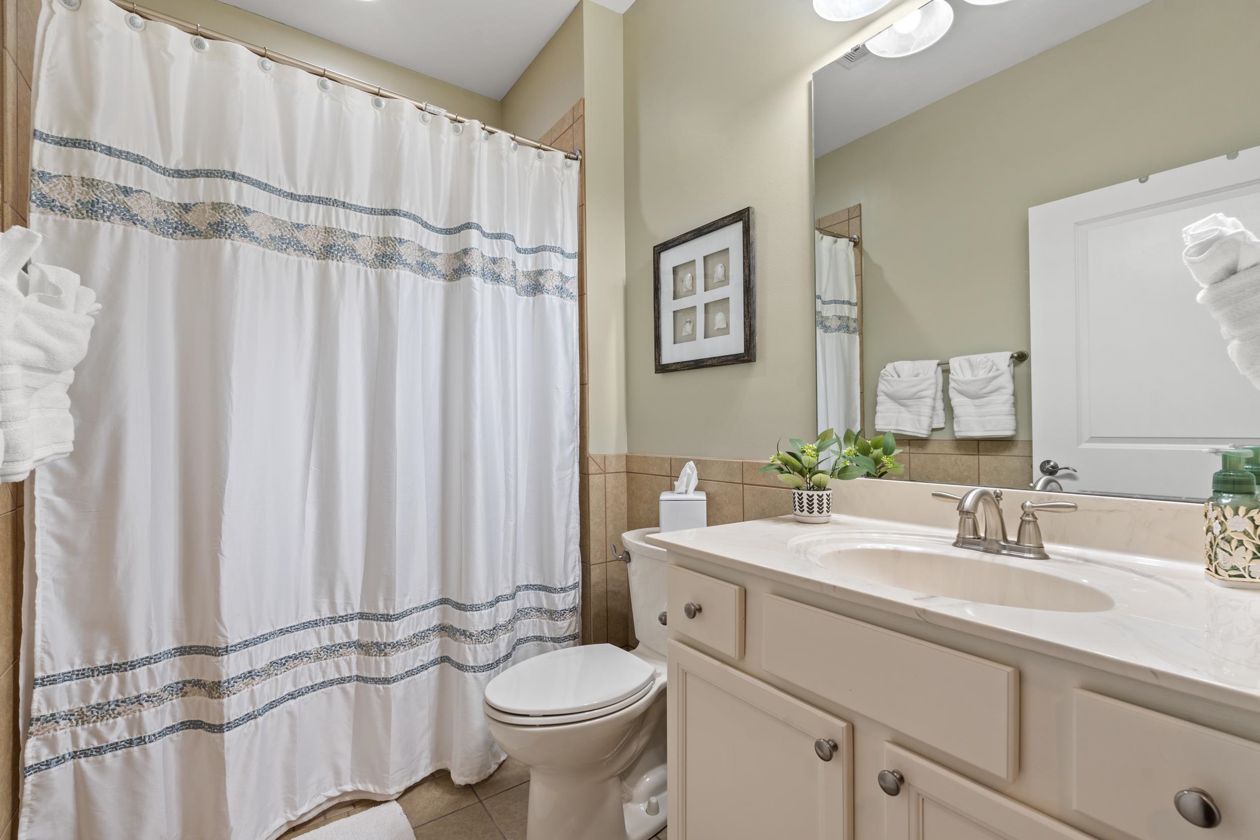 1979 Suncrest Drive Myrtle Beach, SC 29577 - Photo 13 of 28 Full bath with curtained shower, vanity, light tile patterned floors, tile walls, and a wainscoted wall