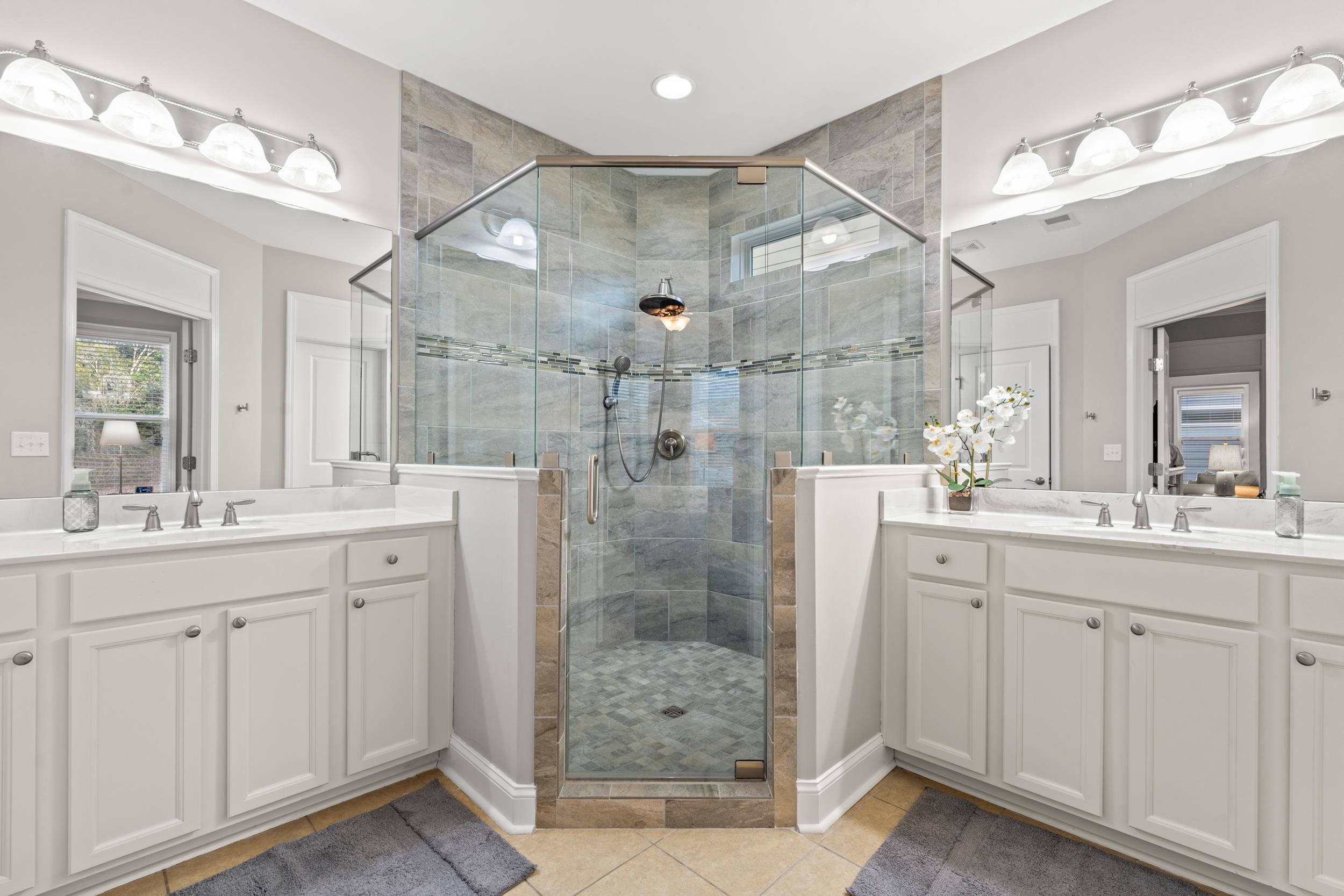 1979 Suncrest Drive Myrtle Beach, SC 29577 - Photo 20 of 28 Bathroom with two vanities, a stall shower, and light tile patterned flooring