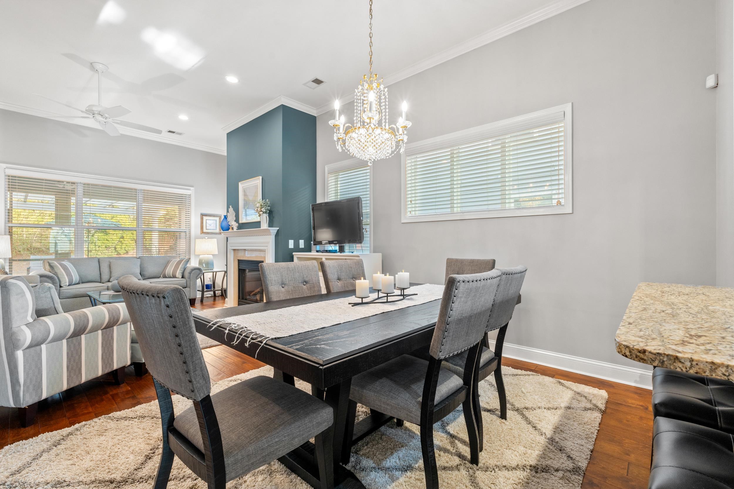 1979 Suncrest Drive Myrtle Beach, SC 29577 - Photo 3 of 28 Dining space featuring a fireplace, healthy amount of natural light, a ceiling fan, dark wood-type flooring, and ornamental molding
