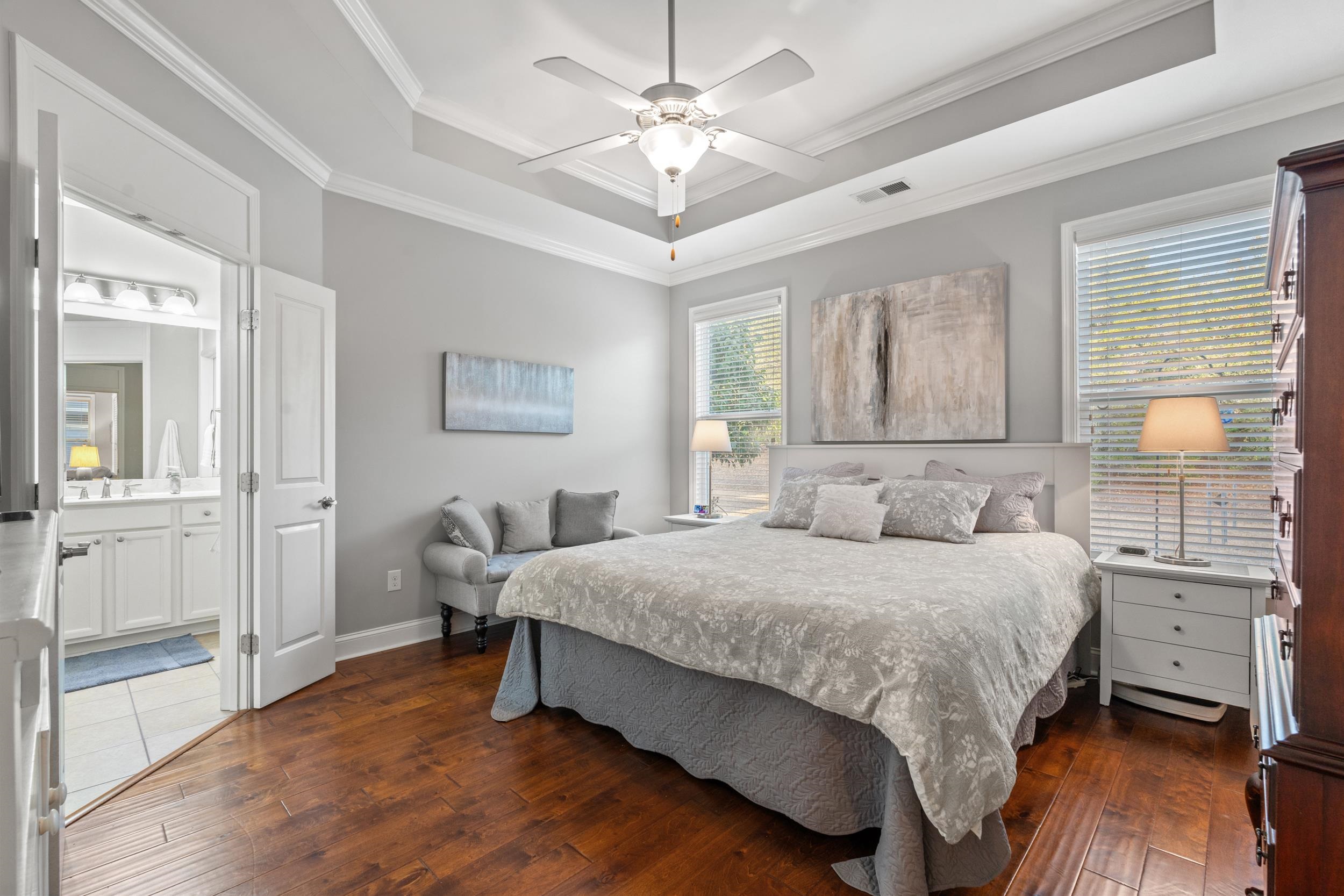 1979 Suncrest Drive Myrtle Beach, SC 29577 - Photo 5 of 28 Bedroom with a raised ceiling, dark wood finished floors, ornamental molding, a ceiling fan, and ensuite bathroom
