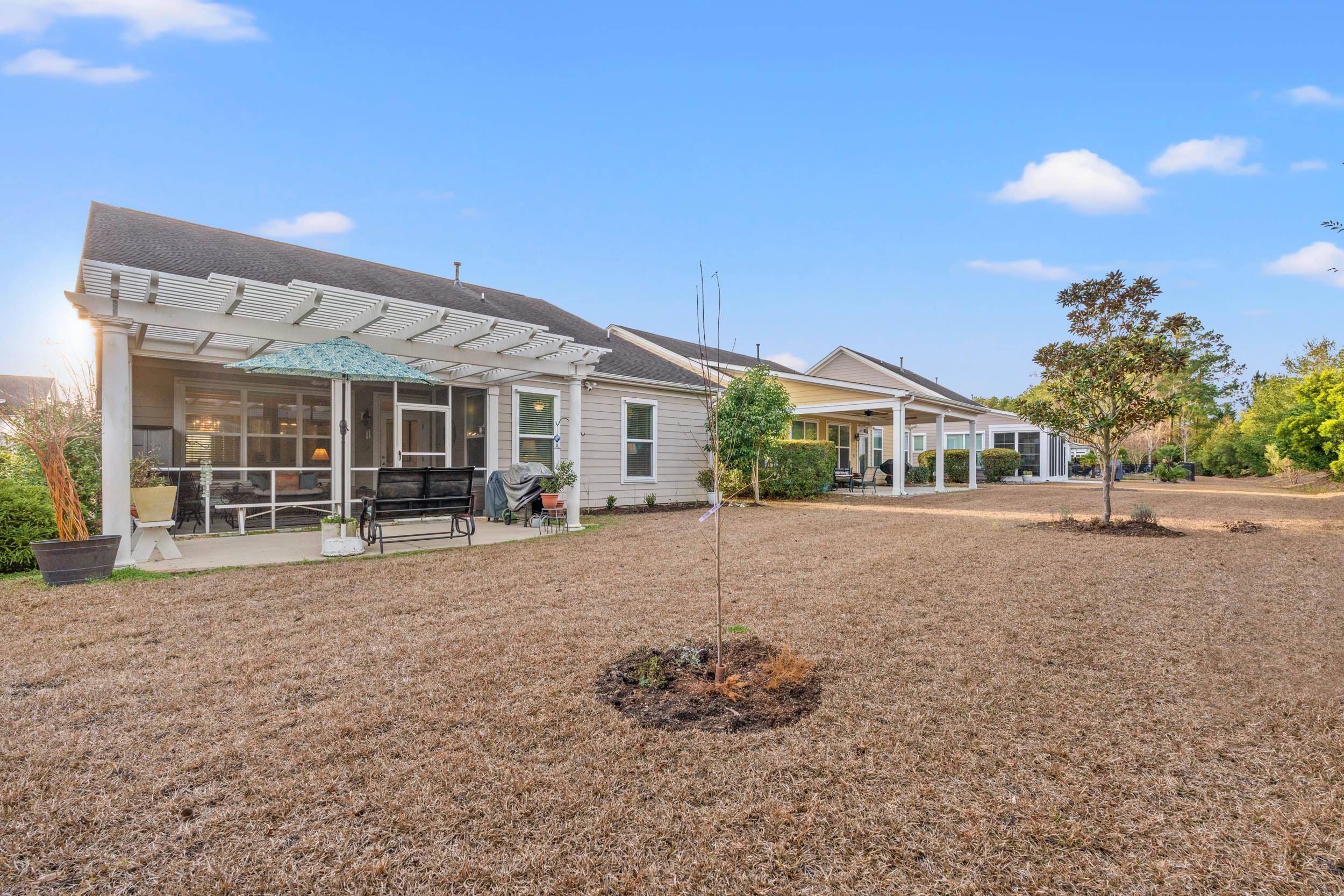 1979 Suncrest Drive Myrtle Beach, SC 29577 - Photo 8 of 28 Back of house featuring a pergola, a patio, and a sunroom