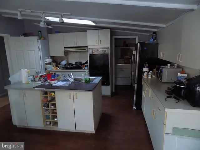 a kitchen with sink a stove and refrigerator