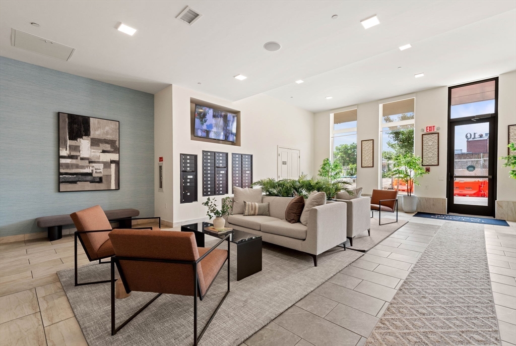 10 Taber Street, Unit 501 Boston, MA 02119 - Photo 31 of 35 a living room with furniture and large windows