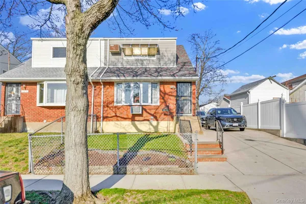 a view of a house with sitting area and yard