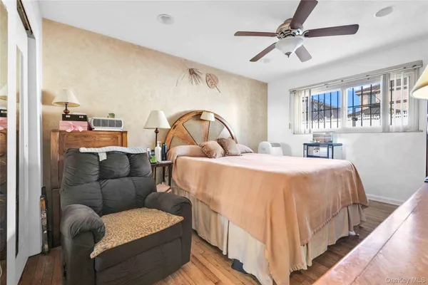 a bedroom with a bed couch and window