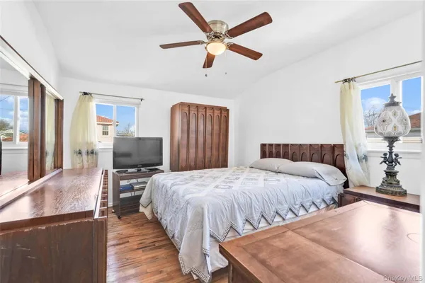 a bedroom with bed and wooden floor