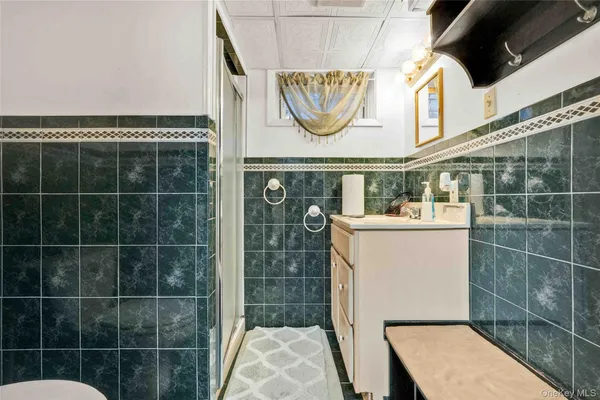 a bathroom with a sink a mirror and a shower