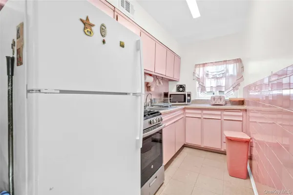 a kitchen with a refrigerator and a sink