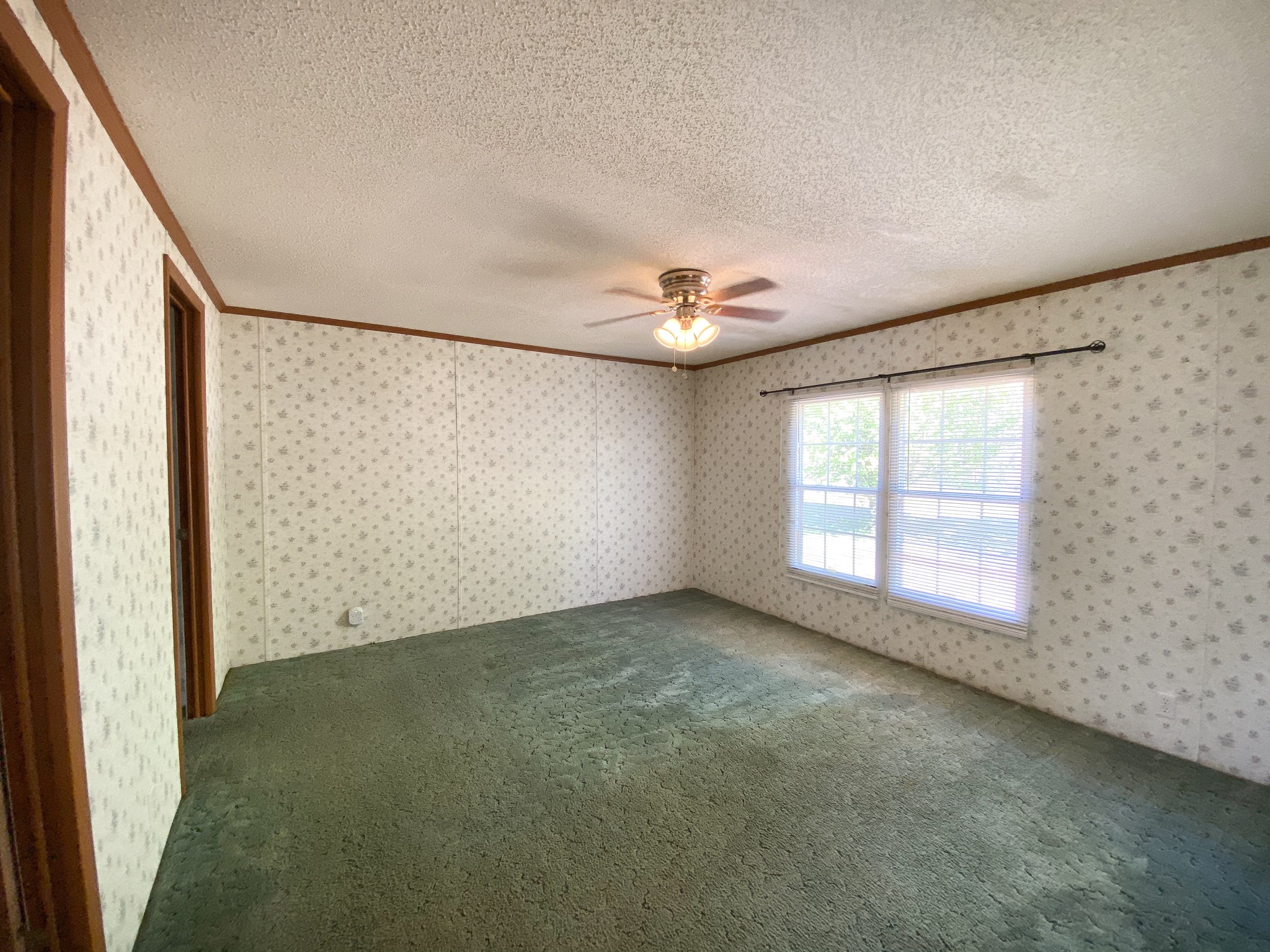 72 Pratt Road Manchester, TN 37355 - Photo 11 of 24 an empty room with windows and chandelier fan