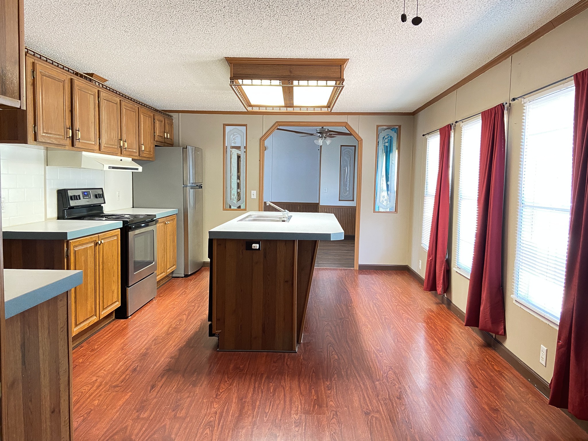 72 Pratt Road Manchester, TN 37355 - Photo 6 of 24 a kitchen with stainless steel appliances granite countertop a refrigerator a sink dishwasher a stove and white countertops with wooden floor