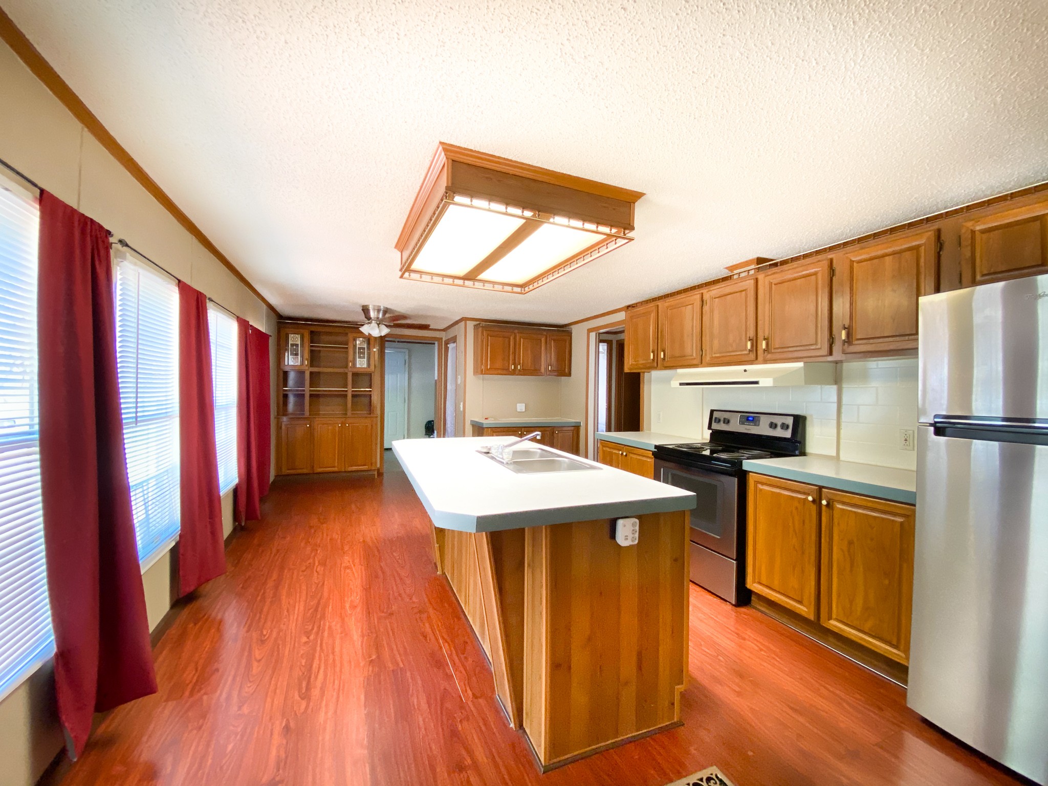 72 Pratt Road Manchester, TN 37355 - Photo 7 of 24 a kitchen with refrigerator a stove and wooden floor