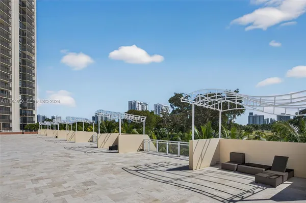 a view of a swimming pool with a outdoor seating and plants