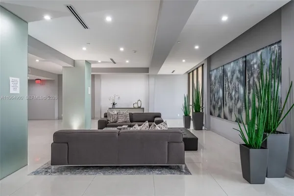 a lobby with furniture and potted plant