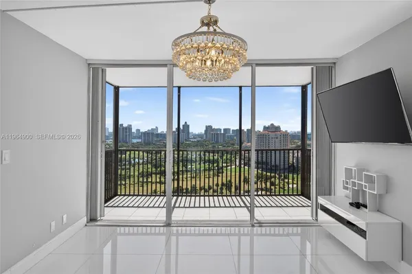 a view of a living room and a floor to ceiling window