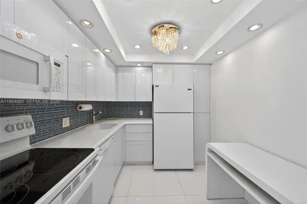 a kitchen with a sink appliances and cabinets