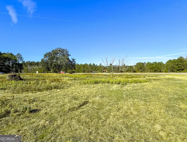 a view of a lake with houses in the back