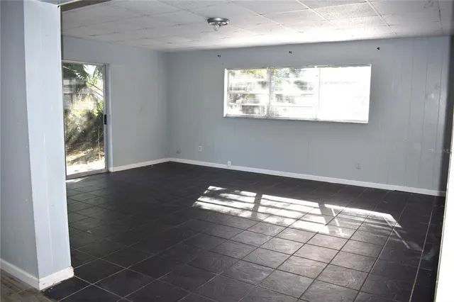 a view of wooden floor and windows in an empty room