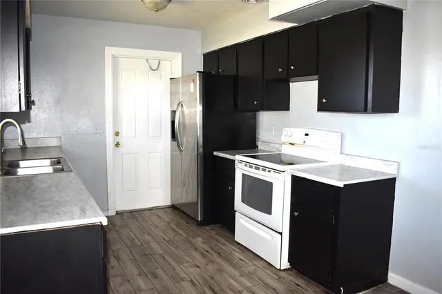 a kitchen with a sink and a refrigerator