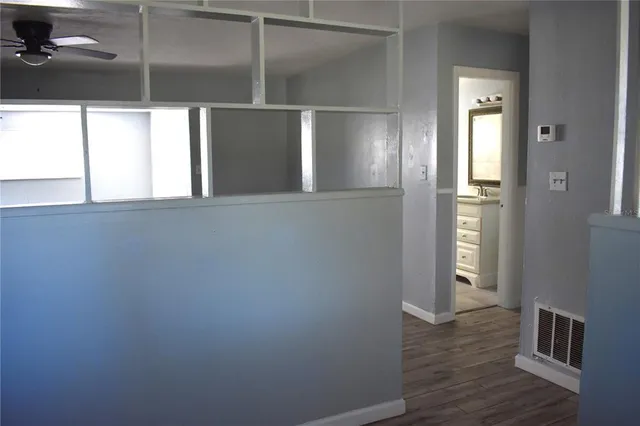 a view of kitchen with a refrigerator and wooden floor
