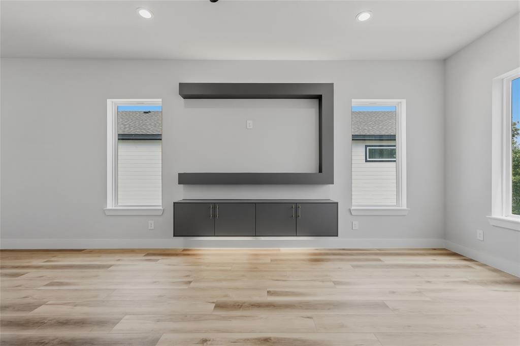 3914 Harlingen Street Dallas, TX 75212 - Photo 15 of 28 a view of an empty room with wooden floor and a window