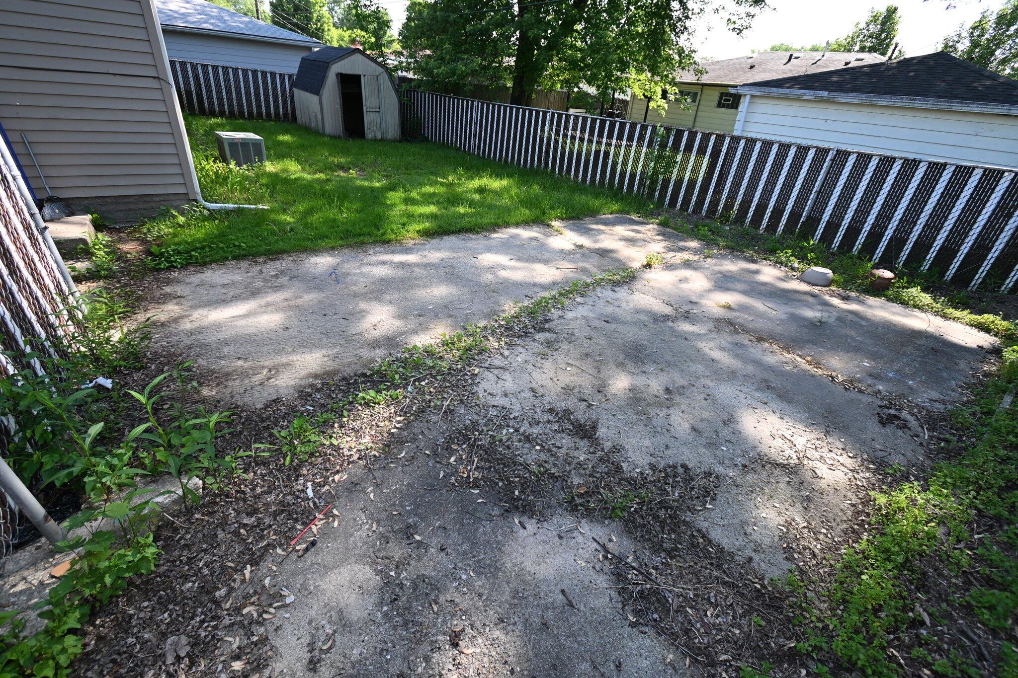 7828 Chestnut Avenue Hammond, IN 46324 - Photo 20 of 23 a view of a yard with swing plants and wooden fence