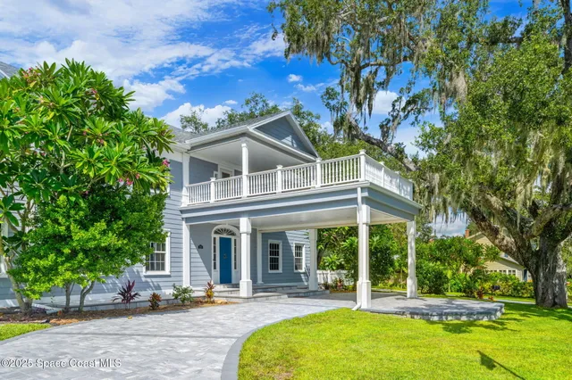a view of living room with furniture and wooden floor