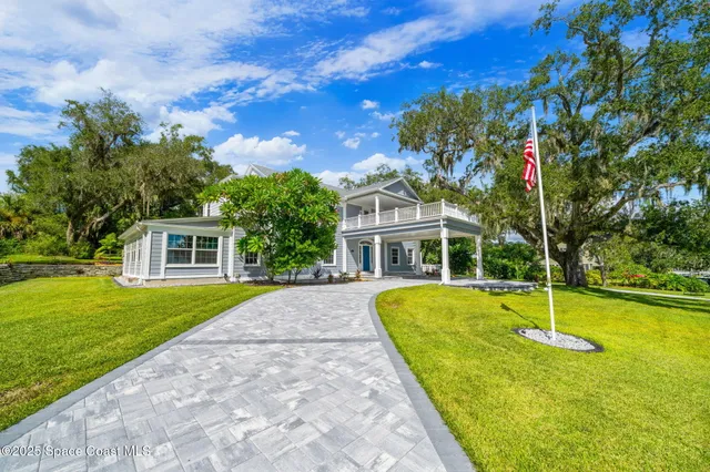 a view of empty room with wooden floor and fireplace