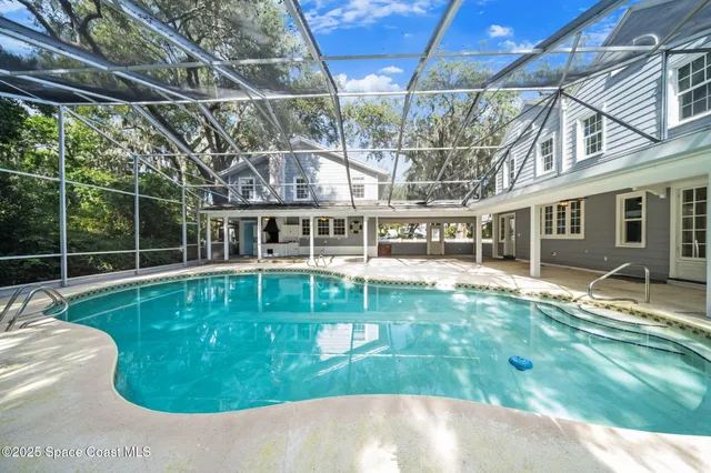 a view of a bedroom with wooden floor and a window
