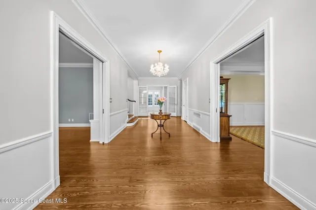 a view of entryway and hall with wooden floor