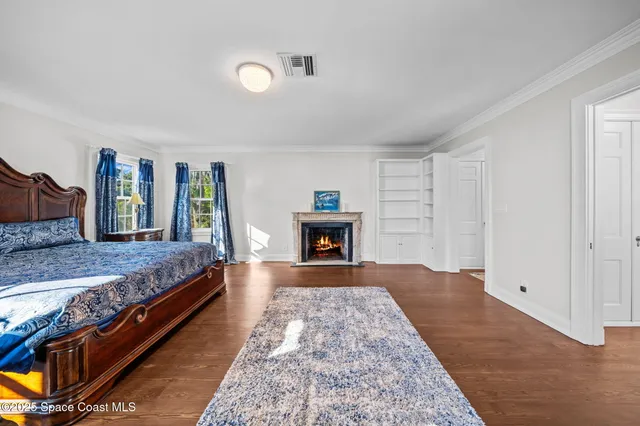 an aerial view of a residential houses with yard