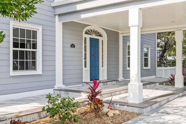 a front view of a house with a yard table and chairs