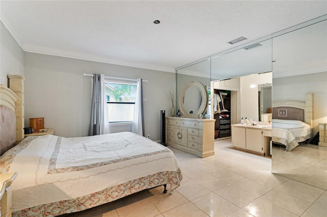 8067 Buttonwood Circle Tamarac, FL 33321 - Photo 11 of 33 a bedroom with a bed and dresser