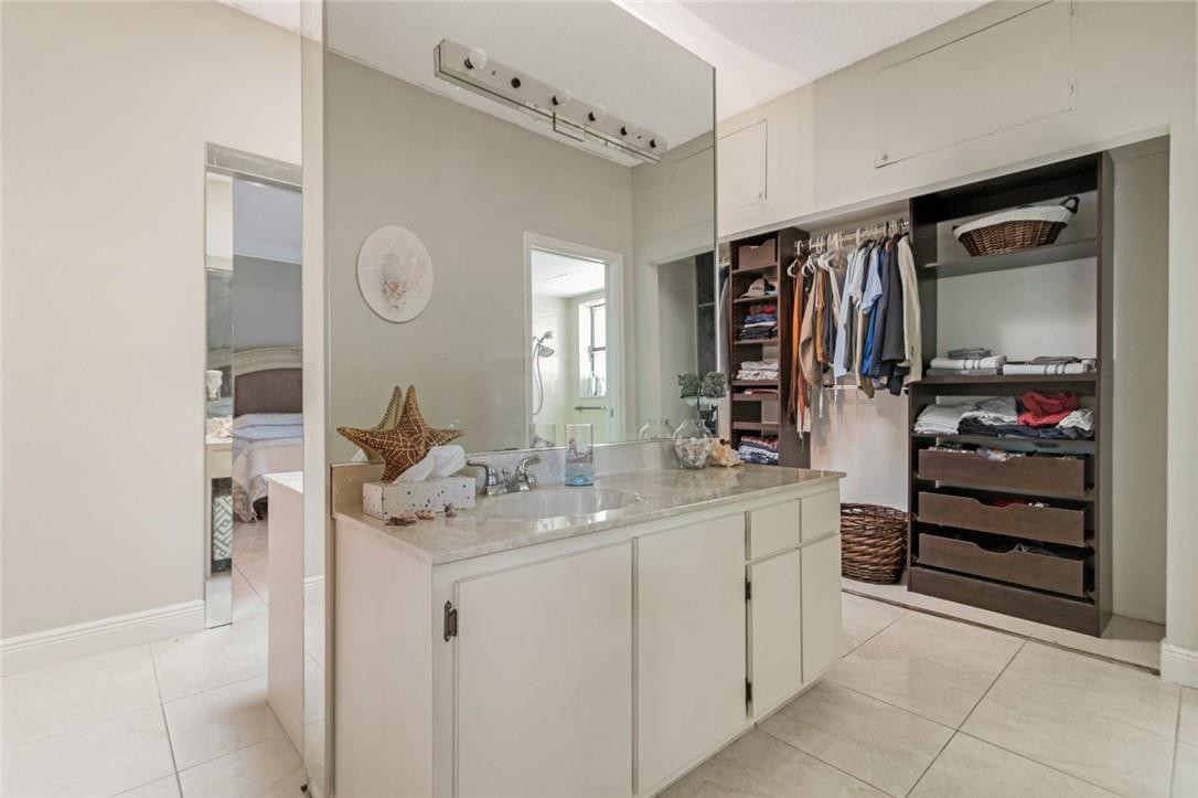 8067 Buttonwood Circle Tamarac, FL 33321 - Photo 13 of 33 a bathroom with a sink vanity and a mirror