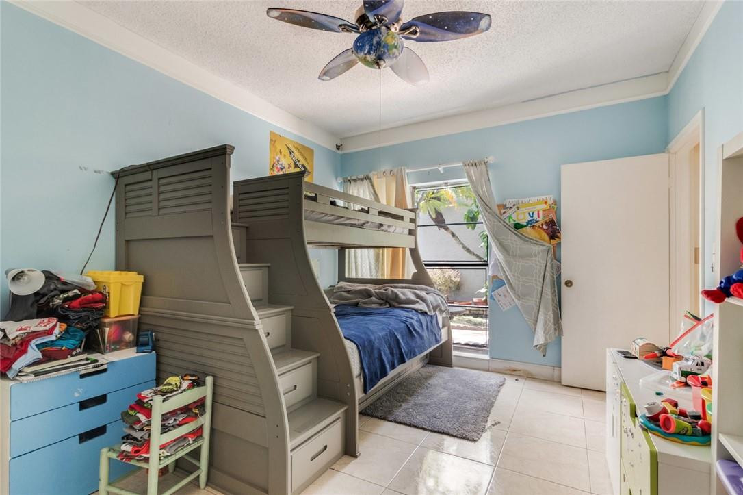 8067 Buttonwood Circle Tamarac, FL 33321 - Photo 15 of 33 a living room with furniture and a baby crib
