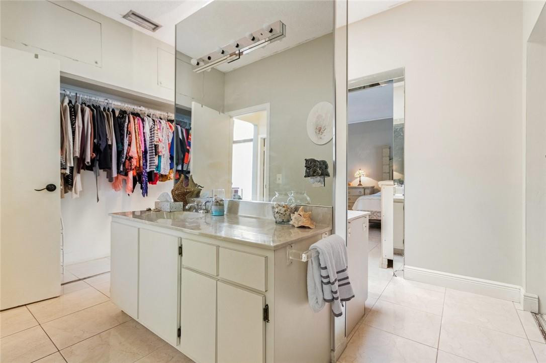 8067 Buttonwood Circle Tamarac, FL 33321 - Photo 24 of 33 a bathroom with a sink vanity and mirror