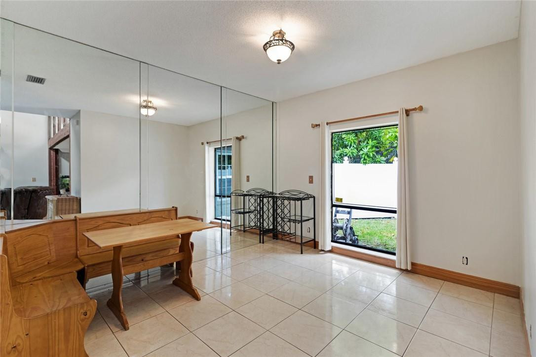 8067 Buttonwood Circle Tamarac, FL 33321 - Photo 26 of 33 a outdoor space with a large window and furniture