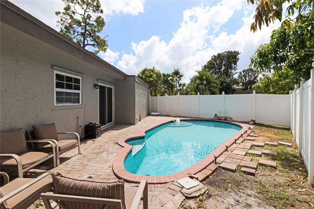 8067 Buttonwood Circle Tamarac, FL 33321 - Photo 27 of 33 a backyard of a house with outdoor seating
