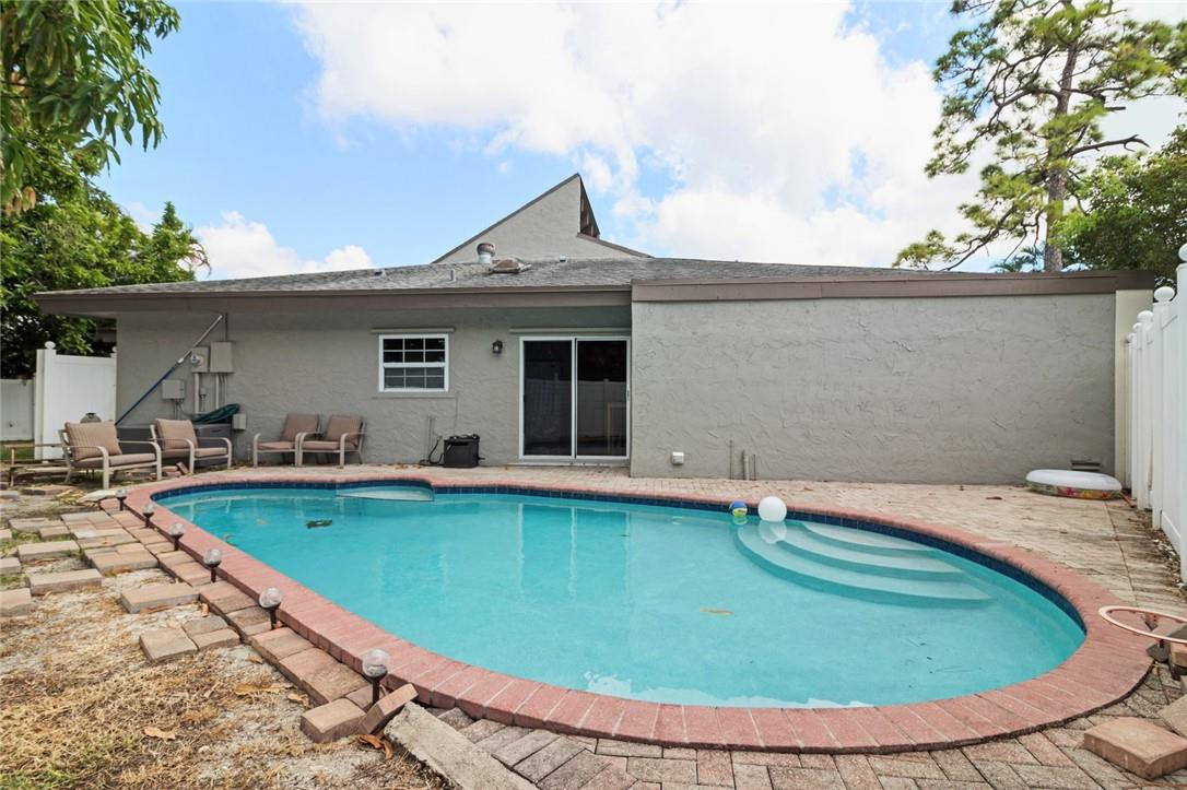 8067 Buttonwood Circle Tamarac, FL 33321 - Photo 28 of 33 a view of a house with swimming pool and porch