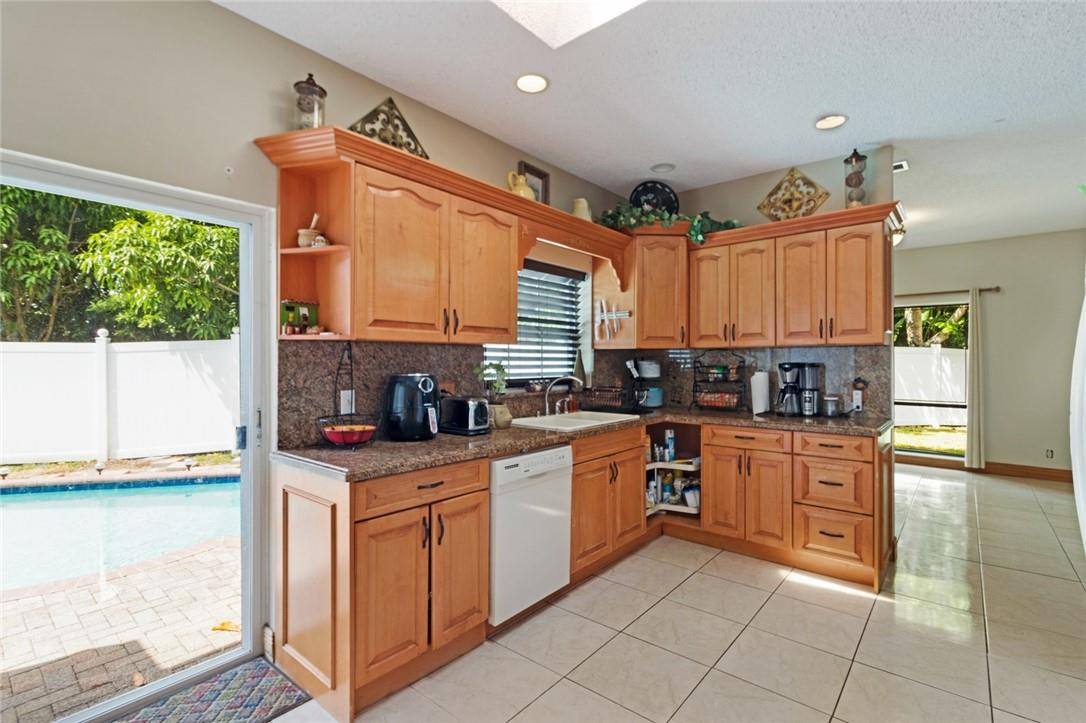 8067 Buttonwood Circle Tamarac, FL 33321 - Photo 3 of 33 a kitchen with stainless steel appliances granite countertop a stove sink and cabinets