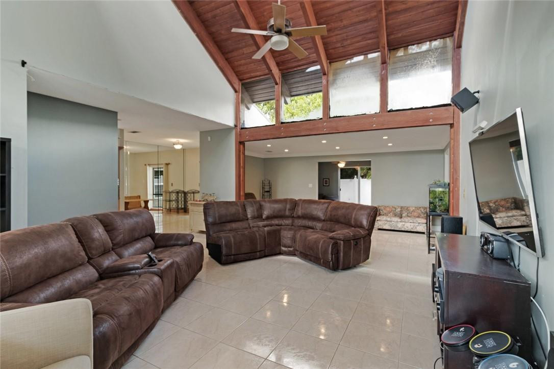 8067 Buttonwood Circle Tamarac, FL 33321 - Photo 4 of 33 a living room with furniture a flat screen tv and a large window