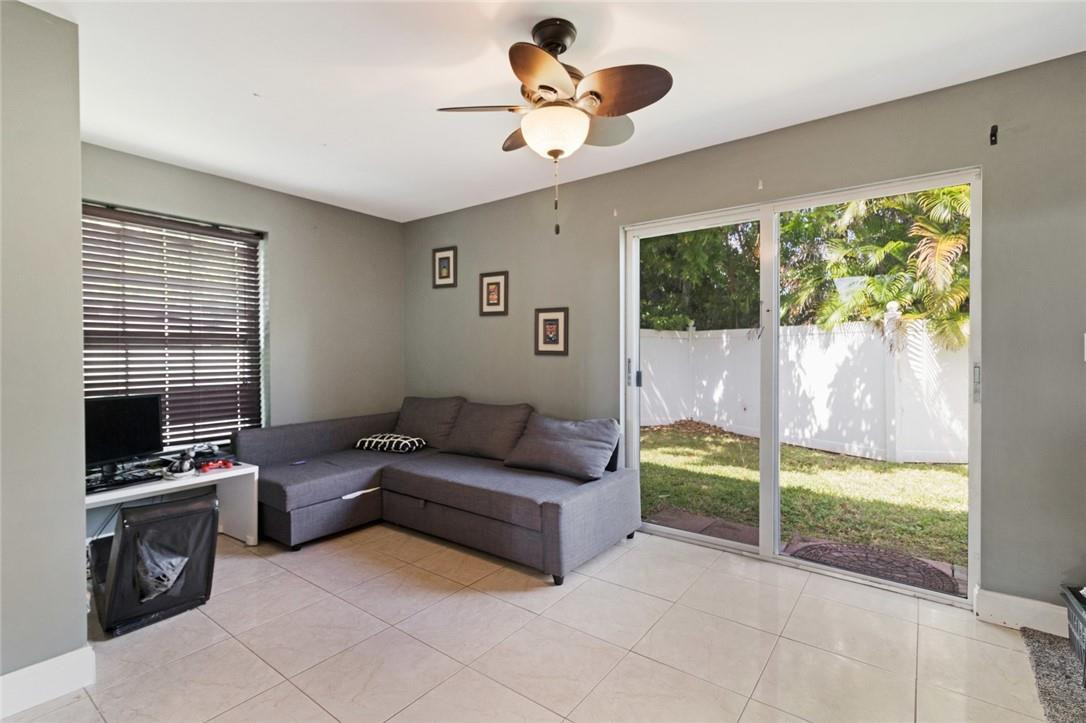8067 Buttonwood Circle Tamarac, FL 33321 - Photo 7 of 33 a living room with furniture and a flat screen tv