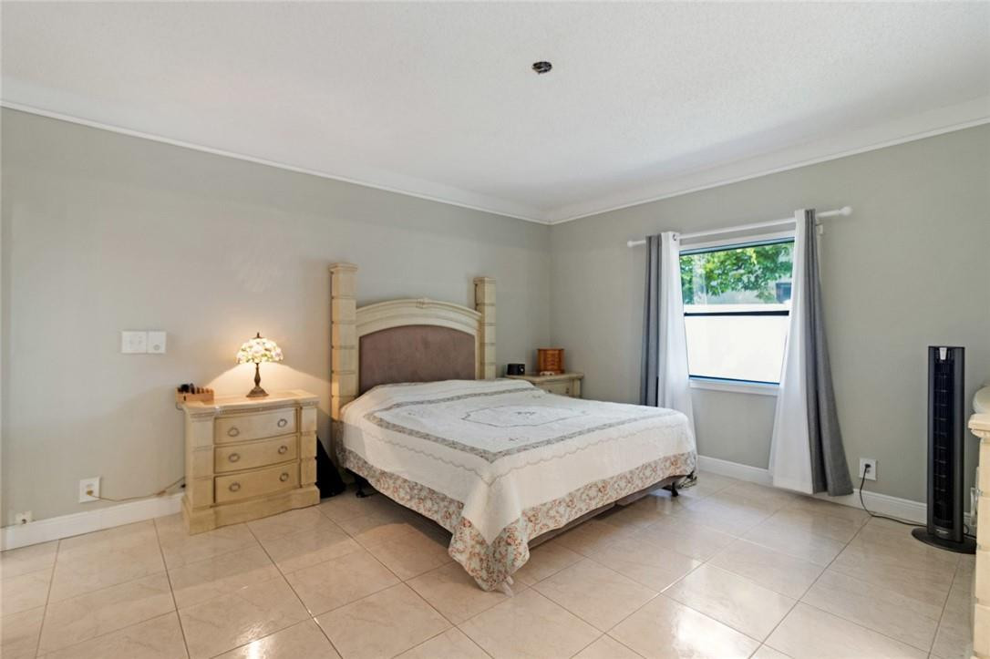 8067 Buttonwood Circle Tamarac, FL 33321 - Photo 9 of 33 a bedroom with a bed and a window