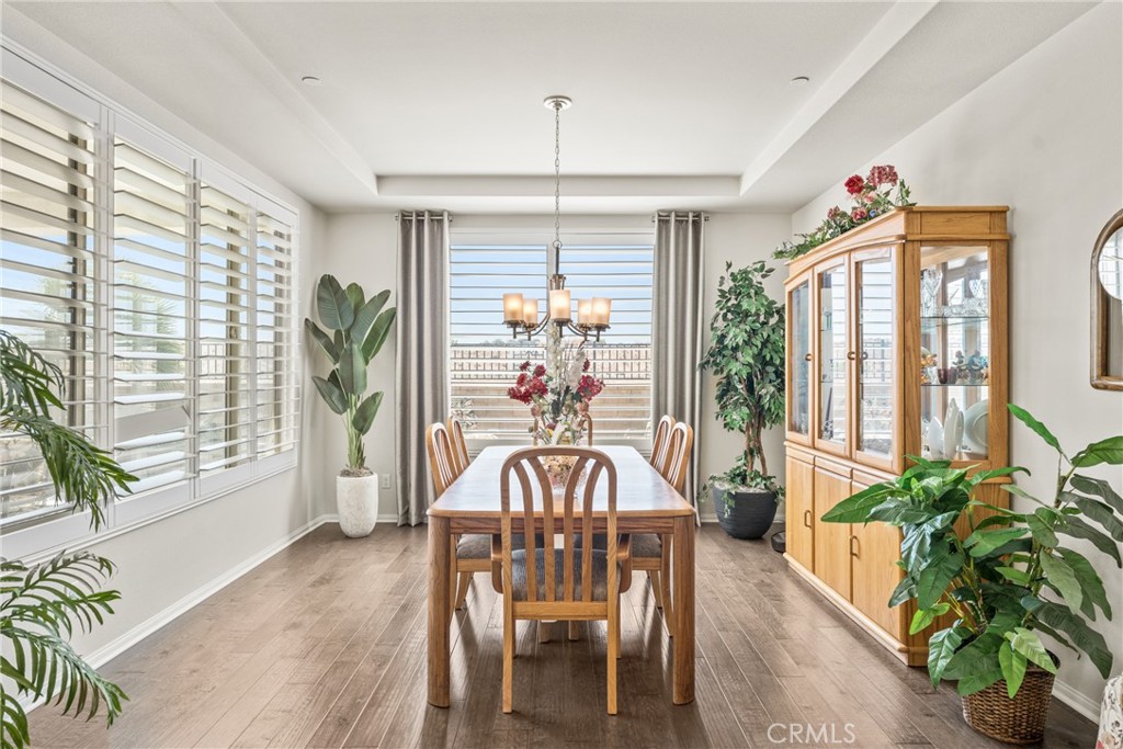 11636 Cascade Street Apple Valley, CA 92308 - Photo 14 of 70 a view of a dining room with furniture window and wooden floor