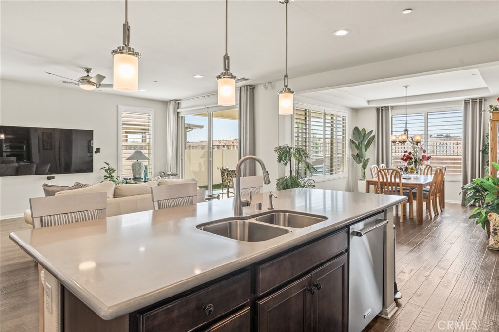 11636 Cascade Street Apple Valley, CA 92308 - Photo 19 of 70 a kitchen with center island a sink stainless steel appliances and living room view