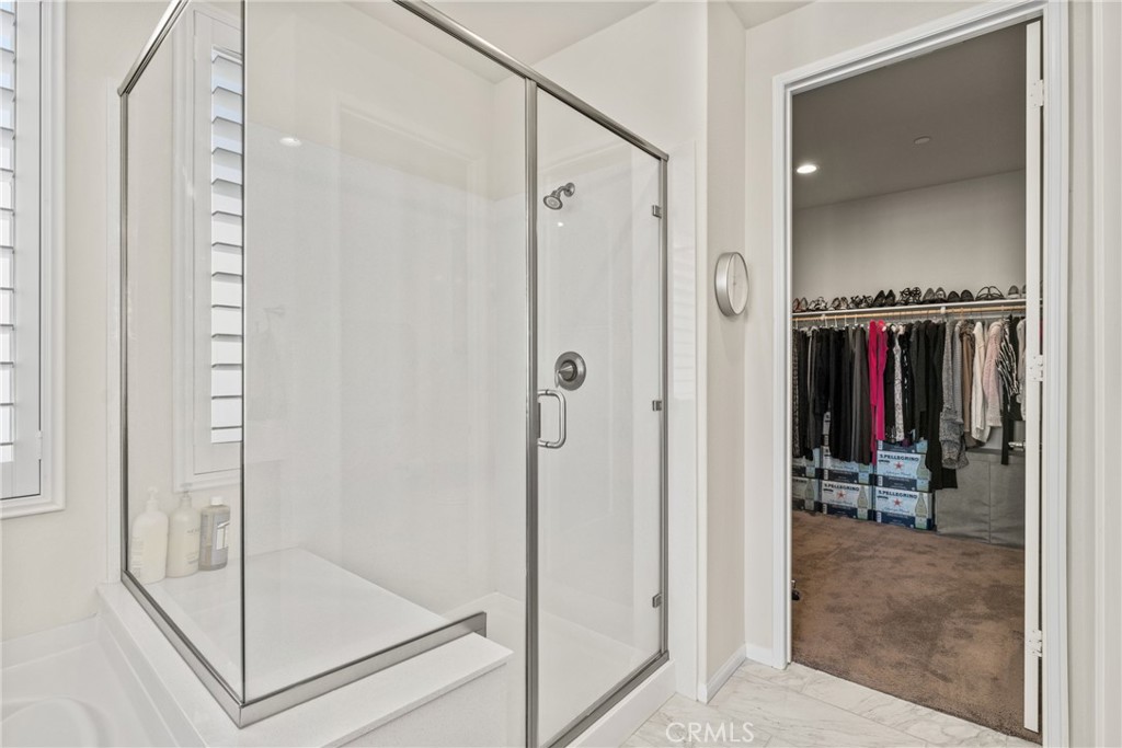 11636 Cascade Street Apple Valley, CA 92308 - Photo 27 of 70 a view of a hallway with closet and a glass door shower