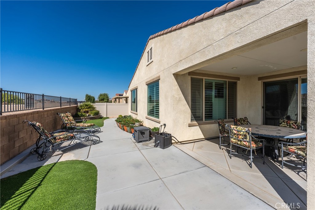 11636 Cascade Street Apple Valley, CA 92308 - Photo 46 of 70 a view of a patio with table and chairs a barbeque