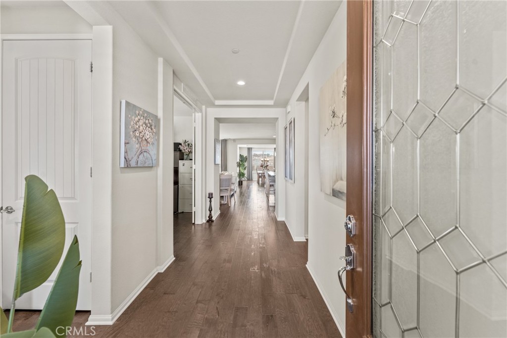 11636 Cascade Street Apple Valley, CA 92308 - Photo 6 of 70 a view of a hallway with wooden floor and stairs