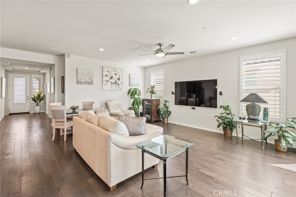 11636 Cascade Street Apple Valley, CA 92308 - Photo 8 of 70 a living room with furniture a flat screen tv and wooden floor